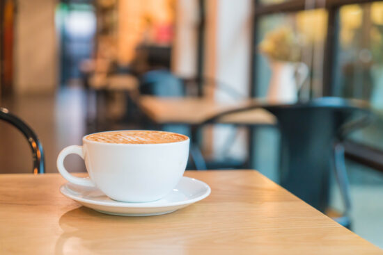 Grab Coffee in Madison WI at Icki Sticki Café with a cozy cup on a wooden table