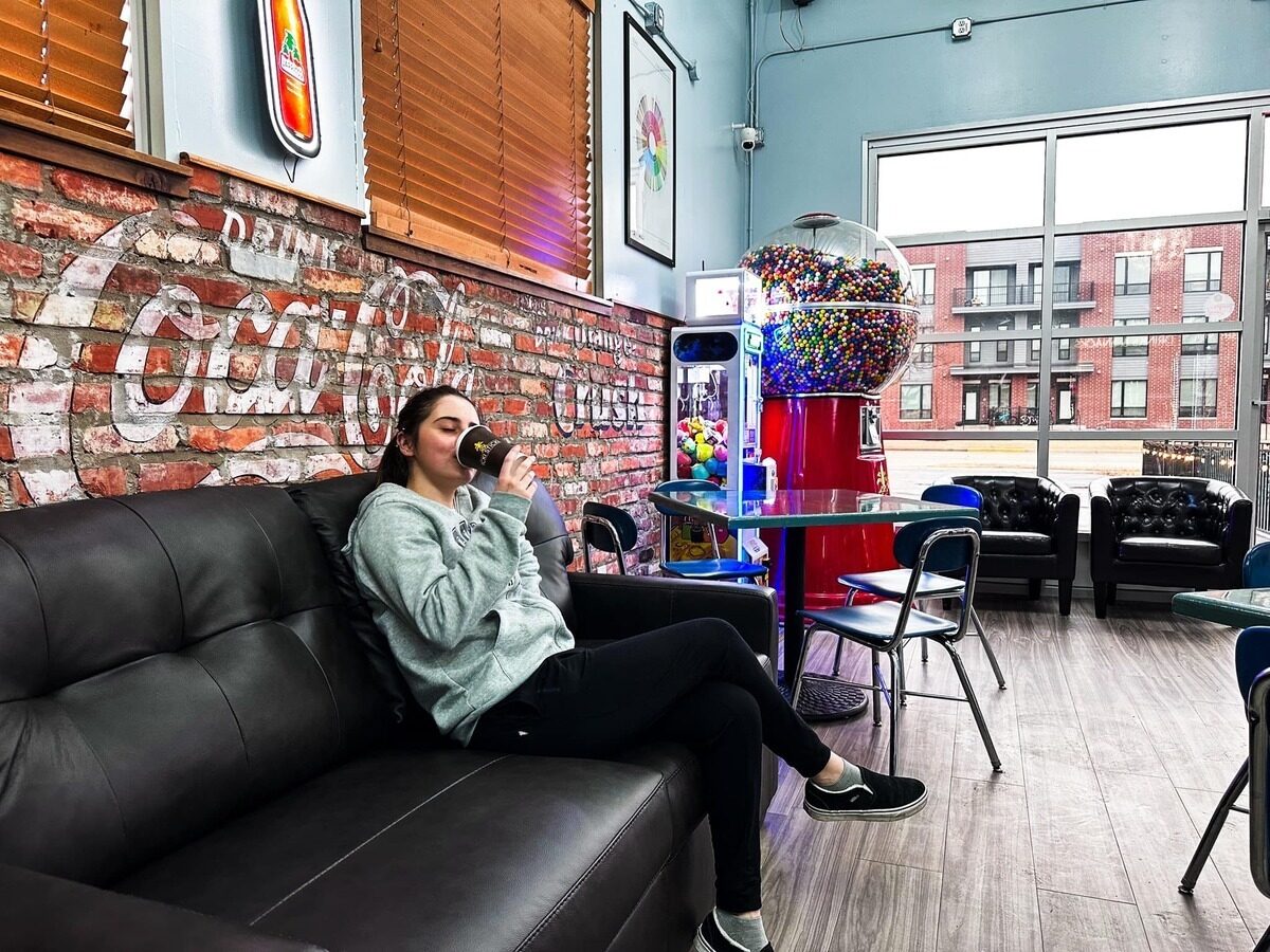 Customer enjoying a drink inside the cafe in Verona WI at Icki Sticki