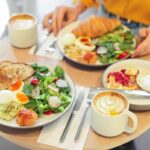 Fresh breakfast plates and lattes on a cafe table at a breakfast cafe near you in Wisconsin