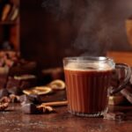 Rich, dark hot chocolate made from melted chocolate steaming in a glass mug, illustrating the hot chocolate vs hot cocoa difference